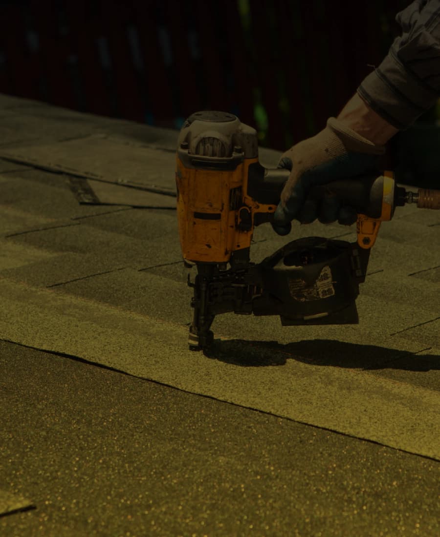 Roofing nailer fastening an asphalt shingle
