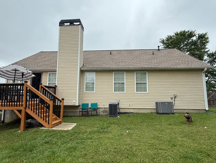 Rear elevation of a home with an asphalt shingle roof