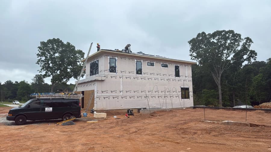 Residential building with exposed exterior weather barrier