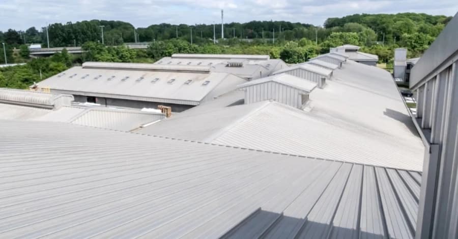 Commercial metal roofing project viewed across long roof sections