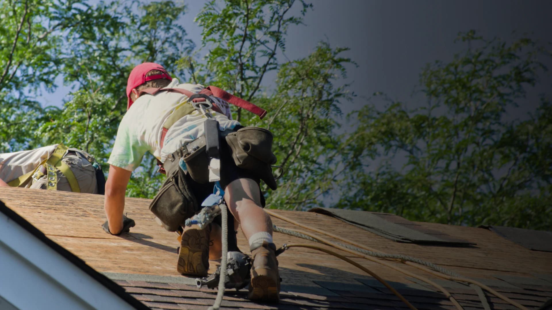 Roofer working on an exposed residential roof deck