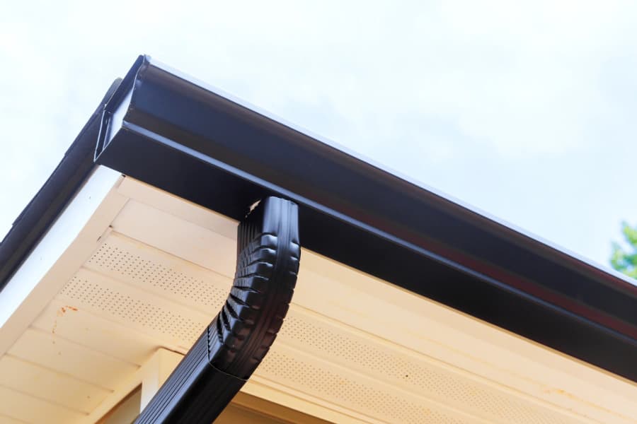 Seamless aluminum gutter following a finished roof edge