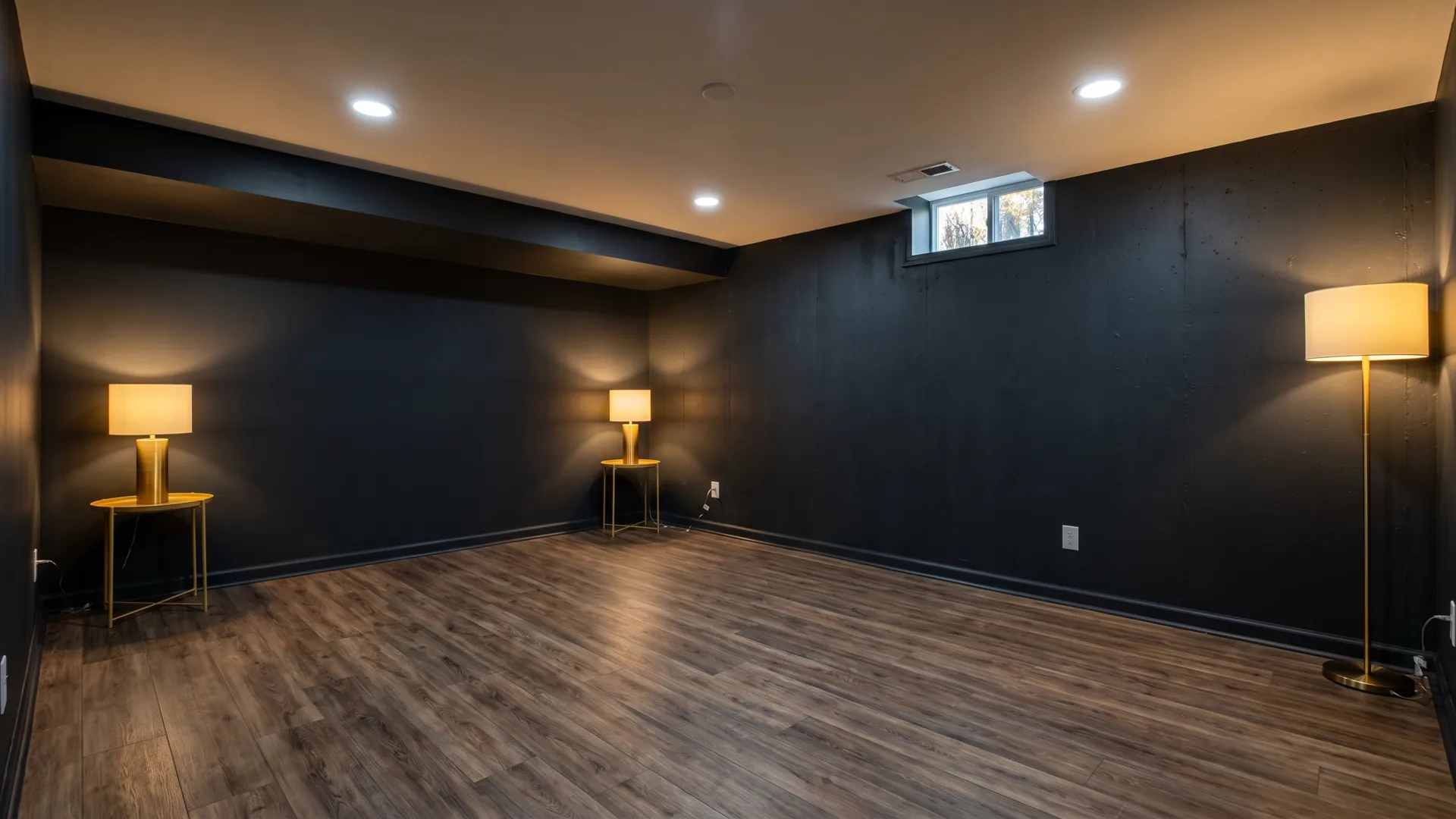Finished below-grade basement rec room with recessed lighting.